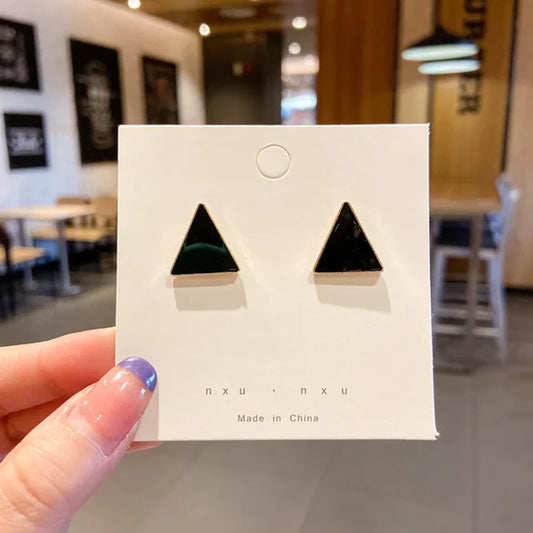 Ladies cute black triangle stud earrings with a gold outline alloy