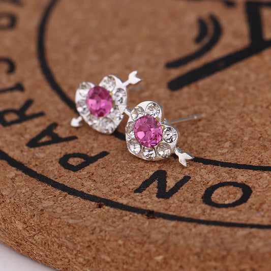 Ladies sparkly cute earrings with a bow through the heart.