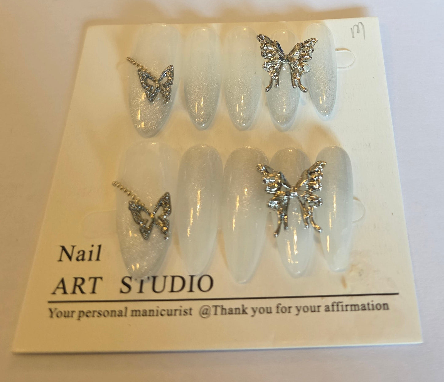 Ladies cateye white with glitter tips and vutterfly charm detail press on nails medium size